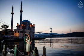 Along the waterfront venue in Ortaköy, Istanbul, the couple enjoys their pre-wedding photo session, with views of the Bosphorus and neighborhood’s iconic backdrop grounding a sense of modern romance.