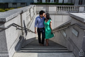 On the steps at UC Berkeley in California, the couple is seen climbing together in a portrait captured from above, their bodies intertwined and smiles evident as the iconic campus scene gently frames their journey.