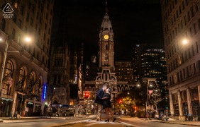 Under the illuminated clock of Philadelphia City Hall, two hearts meet for an engagement portrait, the historic building serving as the perfect backdrop to their quiet connection.