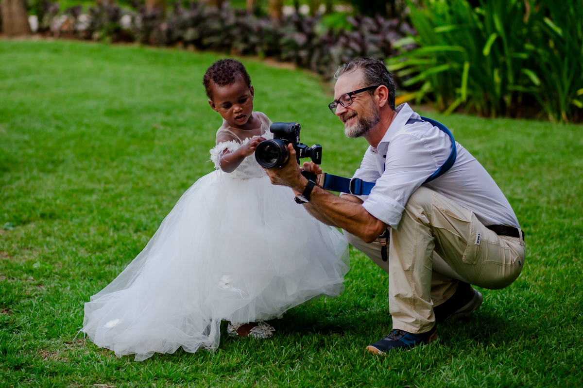 Andrea Martinetti, wedding photographer in Avignon, France, shares camera photos with a little girl in a white dress during a Vaucluse wedding in the PACA region.
