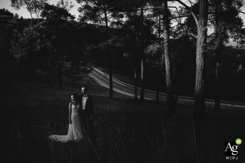 Cappadocia, Kapadokya, Turkey couple posing for wedding images in Cappadocia's forest and there is a road behind them 