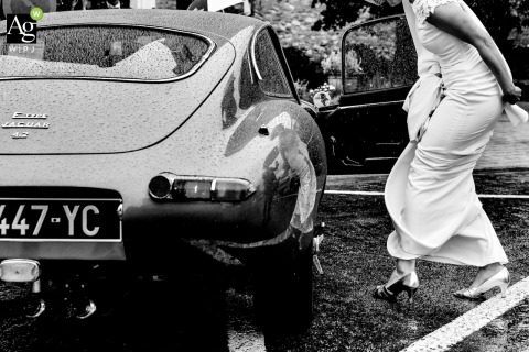 Black and white Paris wedding picture of a France bride eager to join the car at the end of the ceremony