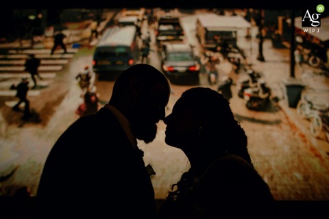 At Silver Cinema on Sauldre, the couple's silhouettes in profile, facing each other in front of the screen