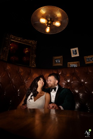 This couple sat in a cozy booth at an Alberta bar in downtown Edmonton, the picture taken with a paparazzi-style flash lighting