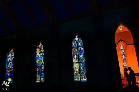 ROSWELL REVERIE: A Wedding Photo Illuminated, Captured, and Composed in Harmony At a church in Roswell, Georgia, the bride and groom stood before the photographers' flash gel, resulting in a beautifully lit, off-center framed portrait session with an artistic touch.