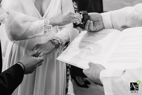 Hands Gently Meet for the Exchange of Rings During Ceremony Vows and Commitment in Vienne, France The exchange of rings takes place at the ceremony location in Vienne, with hands gently meeting to signify the couple’s vows and commitment.