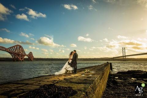On a jetty between the iconic Forth bridges in Edinburgh, the couple embraces as the water and sweeping views set a breathtaking scene at the DoubleTree by Hilton Queensferry Crossing.