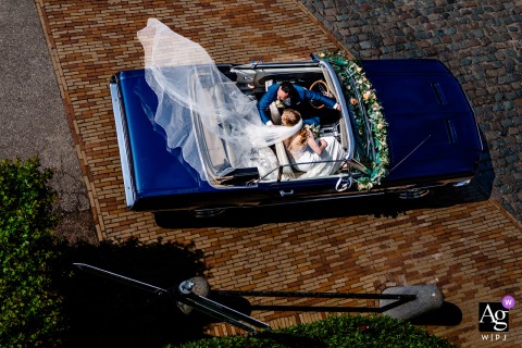 High-angle, bold, and colorful photoshoot of a couple with their car in Gelderland, Netherlands.