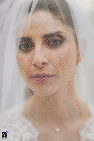 Emotional close-up of a bride's face behind her veil at Vigna Chinet, Turin, capturing the anticipation of her wedding day.