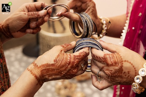 At Greystone in Piedmont Park, Atlanta, an aunt helps the mother of the groom select the perfect bangles for an upcoming traditional fire ceremony during the wedding festivities.