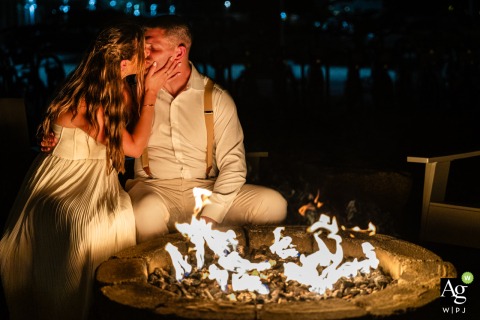 Surrounded by the moonlit air and the soft glow of a fire in Provincetown, Massachusetts, the couple shares an intimate and timeless kiss to celebrate their wedding night.