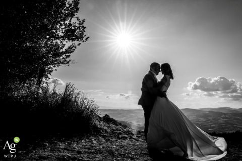 During a rustic country wedding in Duerne within the Monts du Lyonnais, France, the couple shares a quiet, whispered conversation while bathed in the warm, natural afternoon sunlight.