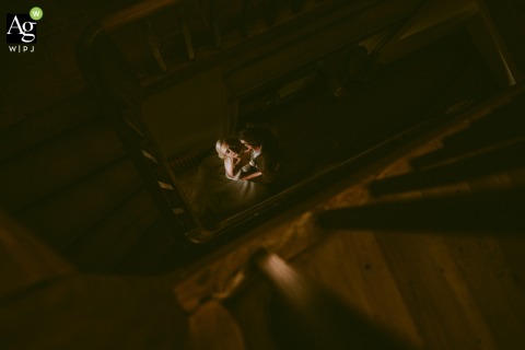 The bride and groom make a grand entrance by walking down a majestic stone staircase at Château Coty in Tarn-et-Garonne, France, during their elegant wedding celebration.