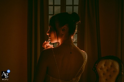 Bride profile shot doing a makeup touch-up at Domaine des Gailardoux, Lot, France.
