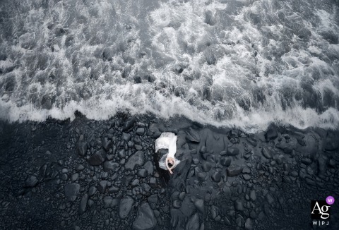 An elevated drone perspective of a bride's portrait captured by the shore in Fujian, China.