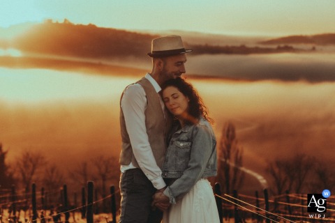 A beautiful, foggy sunrise view of the Sancerre countryside, creating a dreamy backdrop for this couple portrait.