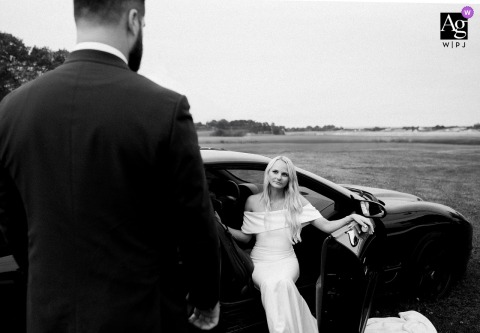 Bride and groom pose by a classic Trans Am at Ogunquit, Maine wedding reception venue.