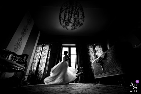 Black and white shot of the bride dancing and spinning at Chateau du Prada, Saint-Lon-les-Mines, France.