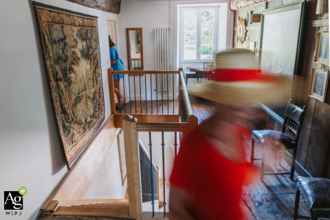 Guests move through the preparation house in Maisonnais-sur-Tardoire, France, creating a candid and bustling scene as the wedding party readies themselves for the upcoming ceremony and events.