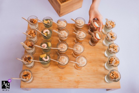 A hungry child's hand eagerly grabs a verrine from a freshly placed tray at Domaine Etxezahar.