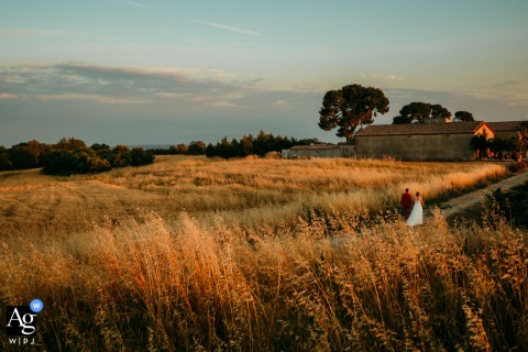 Bride and groom rejoin wedding guests for dinner at Domaine de l’Ale during sunset glow.