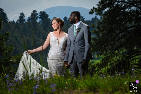 A couple shares a joyful laugh while admiring the scenic view at Christies of Genesee, Colorado.