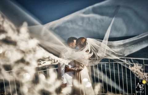 A "Veil of Love" dramatically sweeps across the entire frame in Tellaro, creating a romantic atmosphere for the couple portrait.