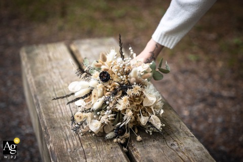 Beautiful Bridal Bouquet Casually Placed on Rustic Wooden Bench at Sixt Fer à Cheval, France A beautiful bridal bouquet is casually placed on a rustic wooden bench at Sixt Fer à Cheval, Haute-Savoie, France.