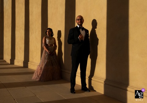 Bride and groom pose at sunset outside Stowehouse, Bucks, UK