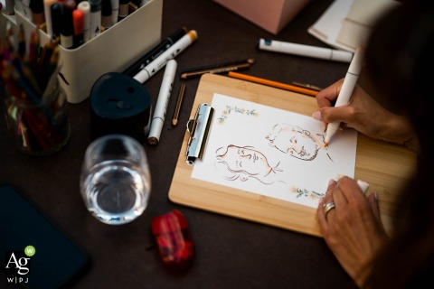 A detailed close-up highlights the work of a portrait artist at a wedding in Mulino dell'olio, Clivio, capturing a unique creative element of the celebration in Lombardy.