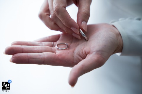 The bride and groom's rings are visible in hands in this detail shot from Hotel HO Jaén, Jaén, Spain.