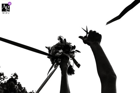 A black and white silhouette of a ribbon-round game at Domaine Clairfontaine, Noyarey, France, set against a white sky background.