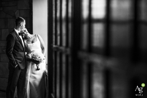 Following their ceremony at the Tudor Arms Hotel in Cleveland, OH, the bride and groom find the perfect light for a romantic and glowing wedding portrait.