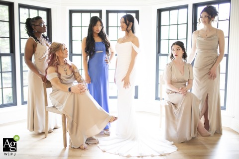 Bridesmaids and the bride bring confidence and sass to their pre-ceremony portrait session at Basil Place Wedding Venue in Chardon, Ohio, showcasing their stylish and upbeat group dynamic.