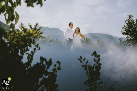 Set against a natural landscape at Yanık Mektep İstanbul, the couple poses for a portrait that incorporates a stunning reflection to create a symmetrical and serene outdoor image.