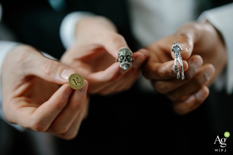 Groomsmen proudly hold out their personalized cufflinks for a detailed group portrait at the bride's house in Annapolis, Maryland, highlighting the unique accessories of the wedding party.