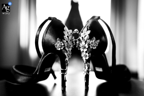 Elegant black and white shot of luxury wedding shoes, artfully arranged in a Canmore hotel room.