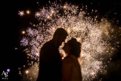 The Inn at Little Washington, Washington VA: Fireworks burst in the background, with the couple's silhouettes softly blurred in the foreground as they look at each other.