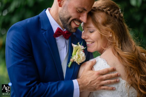 From Halbinsel Au, Zürich, a sensual outdoor portrait captures the couple head-to-head with their eyes closed, sharing warm smiles as his hand rests gently on her back.