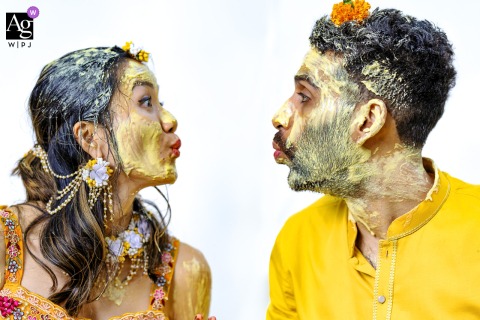 Bride And Groom Turmeric Kiss Portrait On Northside Drive Atlanta Georgia A portrait taken on Northside Drive, Atlanta, captures the bride and groom lovingly puckering up for a kiss, their faces coated in traditional turmeric paste.