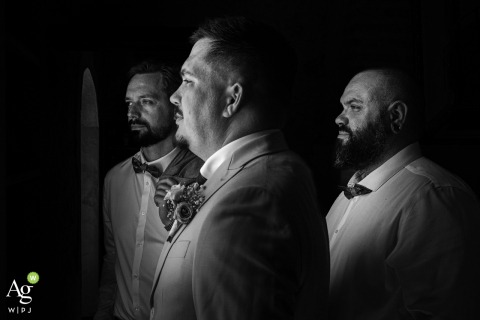 Just before the secular ceremony begins at Château Caillivet in the Gironde region of France, the groom and his groomsmen strike a formal pose on the estate grounds.