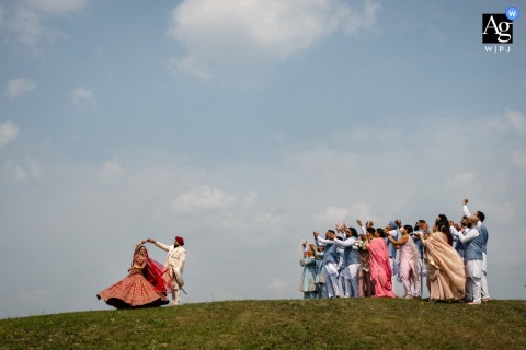 Outside The Leaf in Winnipeg, MB, Canada, the groom joyfully twirls the bride as the bridal party cheers, creating a cheerful scene reminiscent of The Sound of Music.