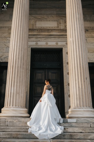 Captured at sunset outside the Cleveland Museum of Art, the bride poses for a portrait as the fading light illuminates the iconic architectural lines of the museum.