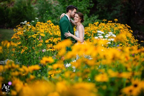 River Bend, Lyons, CO — The bride and groom share a quiet, intimate session among colorful wildflowers, captured in a minimalistic and symmetrical wedding portrait.