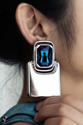 In Fujian, China, earrings offer a unique canvas, capturing tiny, silhouetted reflections of the bride on her wedding day.