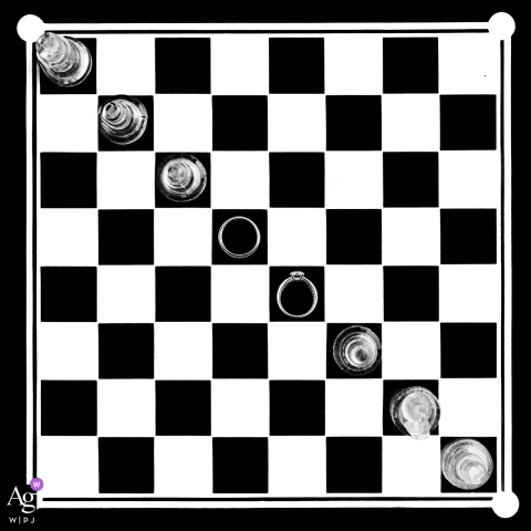 Taian, Shandong is the setting for this artistic wedding day detail showing the couple's rings set atop a chessboard with the pieces dramatically arranged on a diagonal.