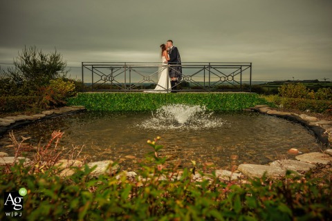 Backlit By Dramatic Flash The Newlyweds Pose On A Bridge At The Radstone Hotel In Larkhall Scotland Backlit by a dramatic off-camera flash, the newlyweds pose on a bridge at the Radstone Hotel in Larkhall, South Lanarkshire.