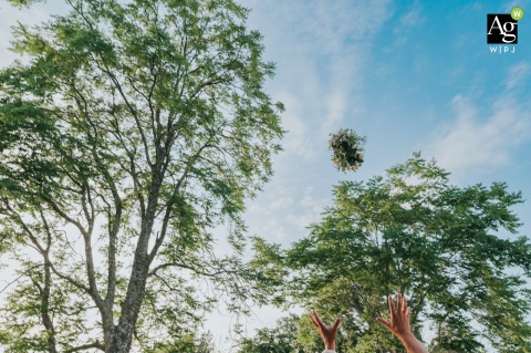 Guests gather outdoors at Château du Grand Moueys in Capian as the bride prepares to toss her bouquet, a classic tradition set against the historic French estate.