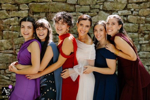Arleta Palace, Navarra, Spain — The bride and her five younger sisters stand in a single line, all smiling and looking strikingly similar, for a joyful family portrait at the wedding venue.