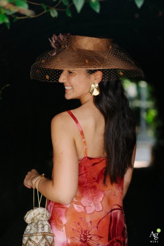 The bride's sister poses for a stylish portrait at El Peregrino Restaurant in Navarra, Spain, showcasing her elegant outfit during the destination wedding celebration.